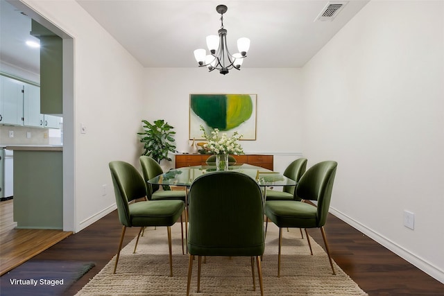 dining room with dark wood-type flooring, visible vents, a notable chandelier, and baseboards