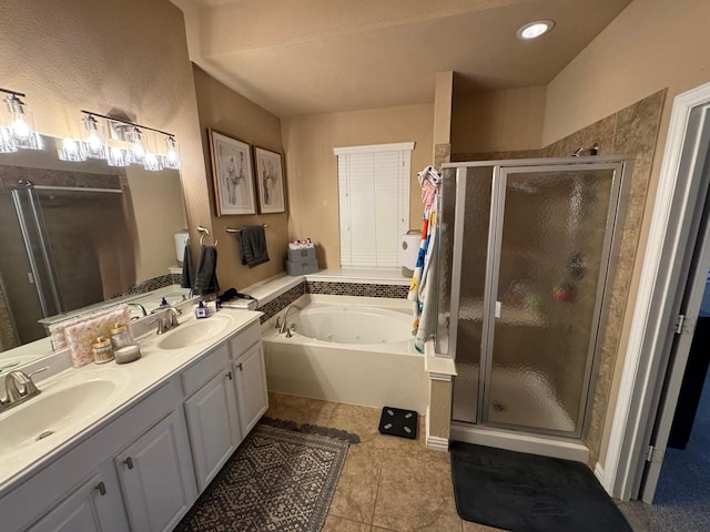 full bath with double vanity, a shower stall, a tub with jets, and a sink