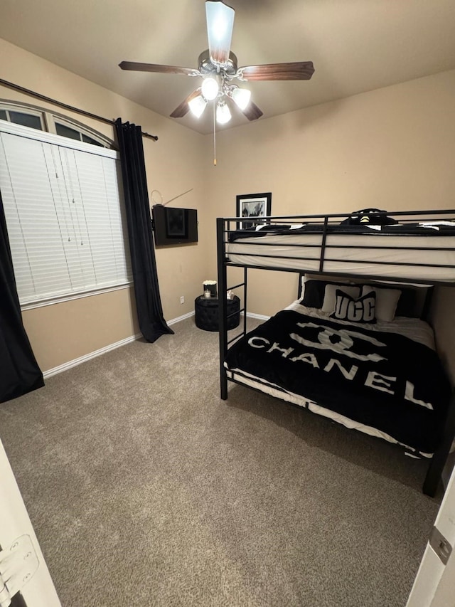 carpeted bedroom with a ceiling fan and baseboards