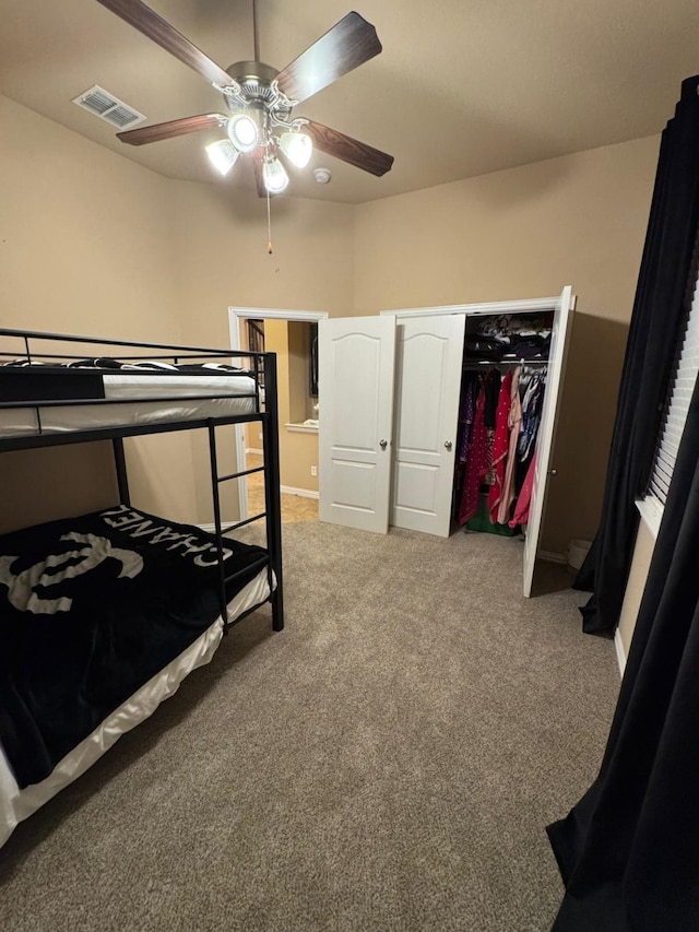 bedroom with a ceiling fan, light colored carpet, a closet, and visible vents