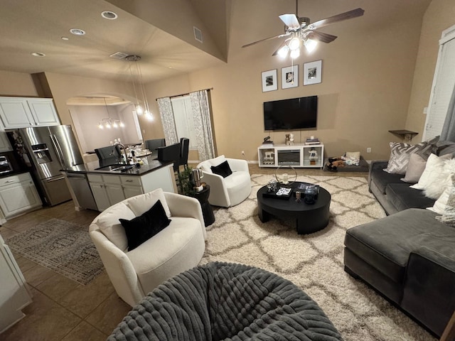 tiled living area featuring ceiling fan with notable chandelier, a sink, visible vents, and recessed lighting