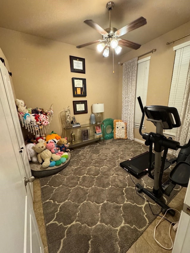 exercise room with a ceiling fan