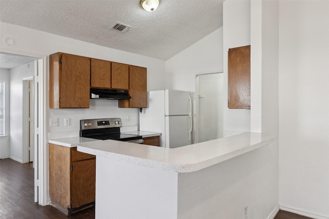 kitchen featuring under cabinet range hood, light countertops, stainless steel electric range, freestanding refrigerator, and brown cabinets