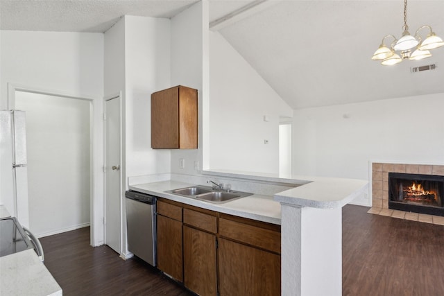 kitchen with visible vents, dishwasher, freestanding refrigerator, light countertops, and a sink