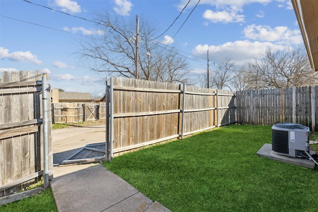 view of yard featuring a fenced backyard, central AC unit, and a patio