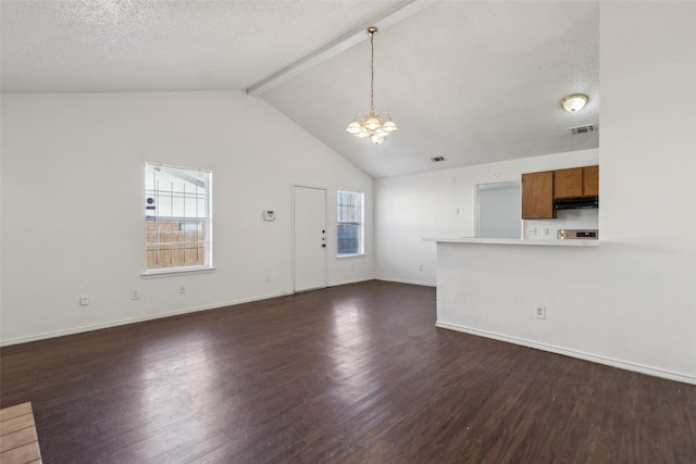 unfurnished living room featuring a chandelier, a wealth of natural light, dark wood-style flooring, and visible vents