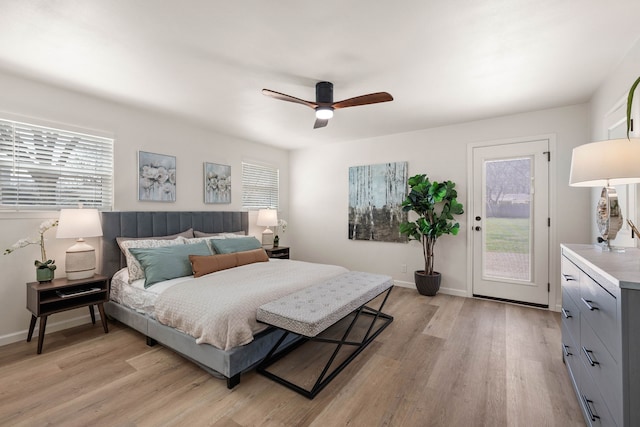 bedroom featuring access to exterior, baseboards, and light wood finished floors