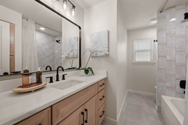 bathroom with tile patterned floors, vanity, and baseboards