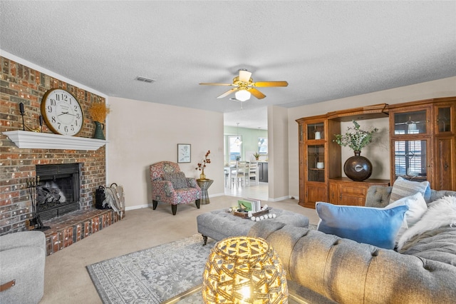 living room with a brick fireplace, carpet, baseboards, and a textured ceiling