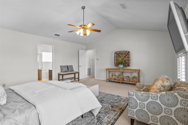 bedroom featuring ceiling fan, visible vents, vaulted ceiling, and light colored carpet