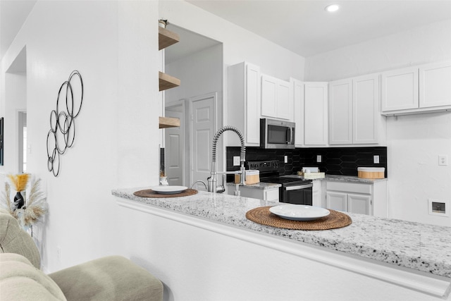 kitchen with white cabinetry, black electric range, open shelves, tasteful backsplash, and stainless steel microwave