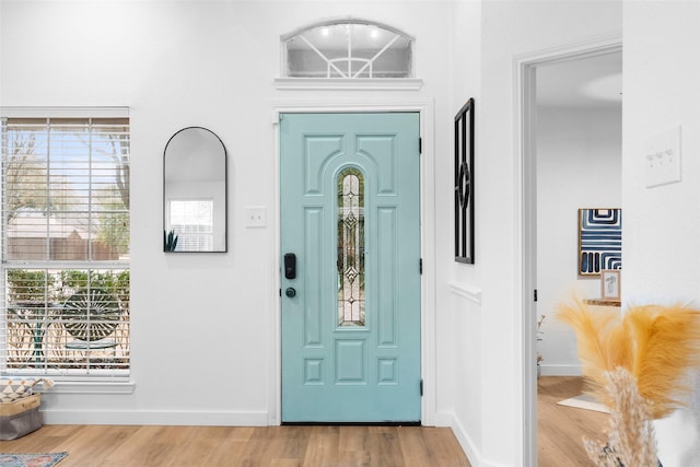 foyer with baseboards and wood finished floors