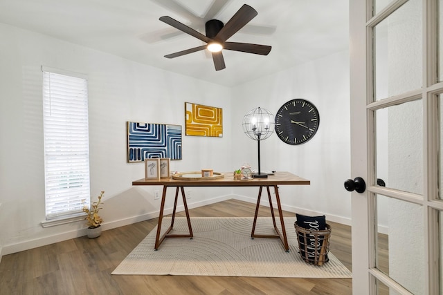 home office with ceiling fan, baseboards, and wood finished floors