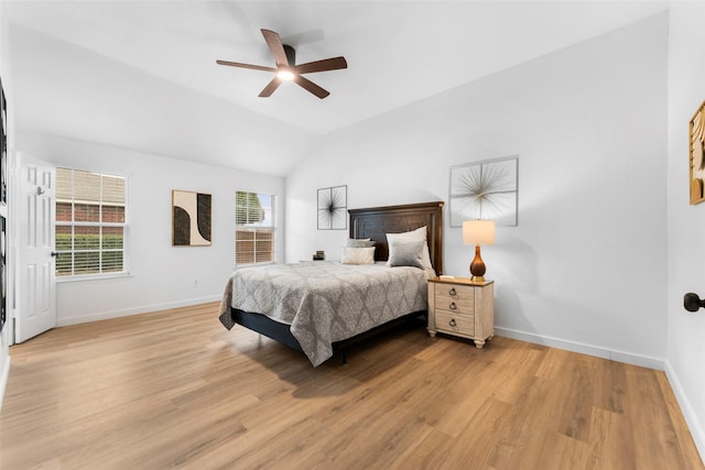 bedroom featuring vaulted ceiling, ceiling fan, light wood-type flooring, and baseboards