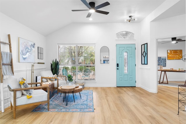 foyer entrance featuring lofted ceiling, light wood finished floors, baseboards, and a ceiling fan