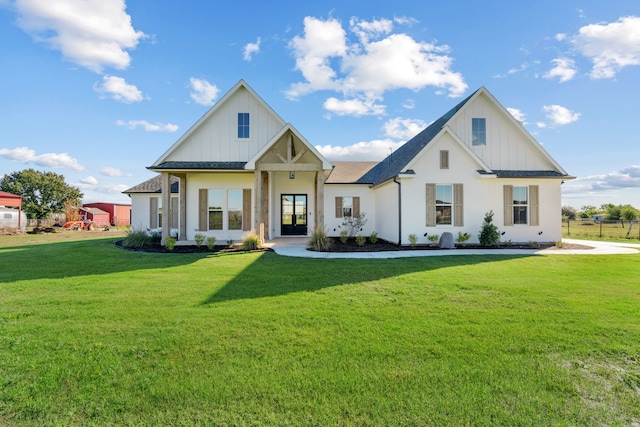 modern farmhouse style home featuring board and batten siding, a front yard, and a shingled roof