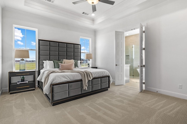 bedroom with light colored carpet, visible vents, baseboards, ornamental molding, and a raised ceiling