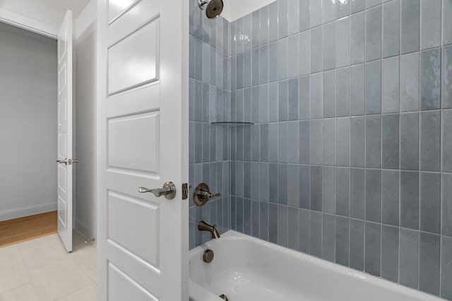 full bathroom featuring shower / bath combination and baseboards