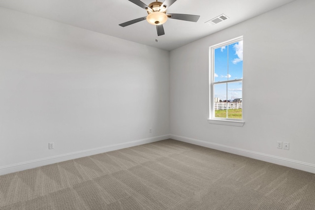 unfurnished room featuring light carpet, baseboards, visible vents, and ceiling fan