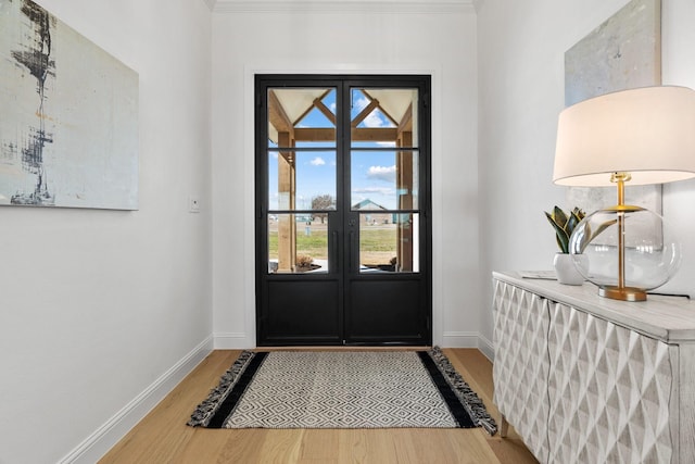 doorway featuring light wood-style flooring, baseboards, and french doors