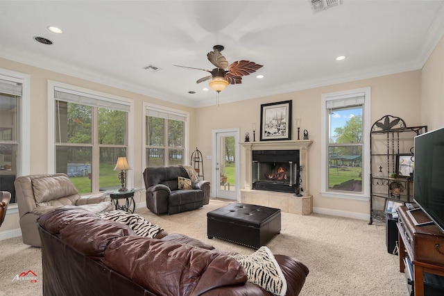 carpeted living room with ornamental molding, a tile fireplace, visible vents, and baseboards