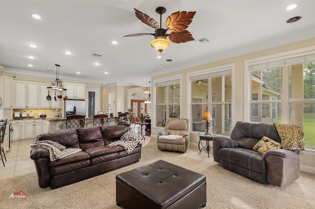 living area featuring light tile patterned floors, ceiling fan, recessed lighting, visible vents, and crown molding