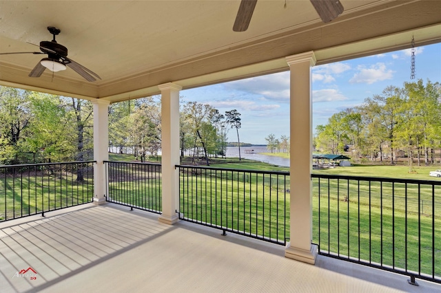 exterior space with a water view, a balcony, and a ceiling fan