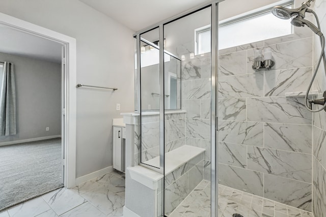 full bathroom with marble finish floor, a shower stall, vanity, and baseboards