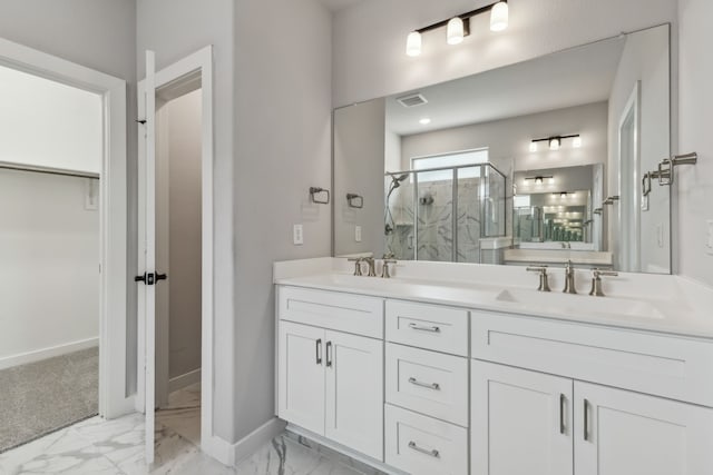 full bath with double vanity, a stall shower, marble finish floor, and a sink