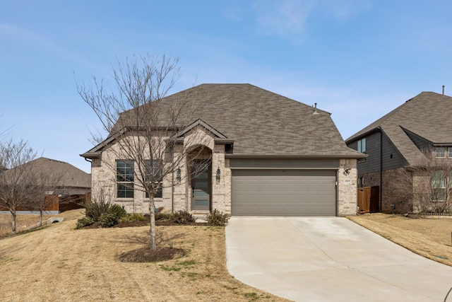 view of front of house with a garage, concrete driveway, brick siding, and a shingled roof