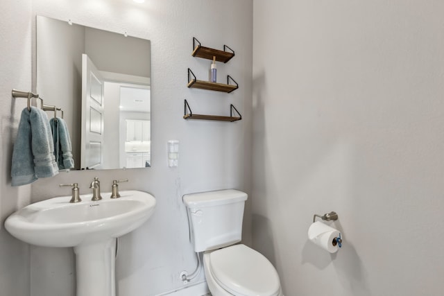 bathroom featuring toilet and a sink