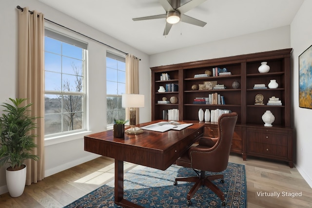 office featuring light wood-type flooring, ceiling fan, and a wealth of natural light