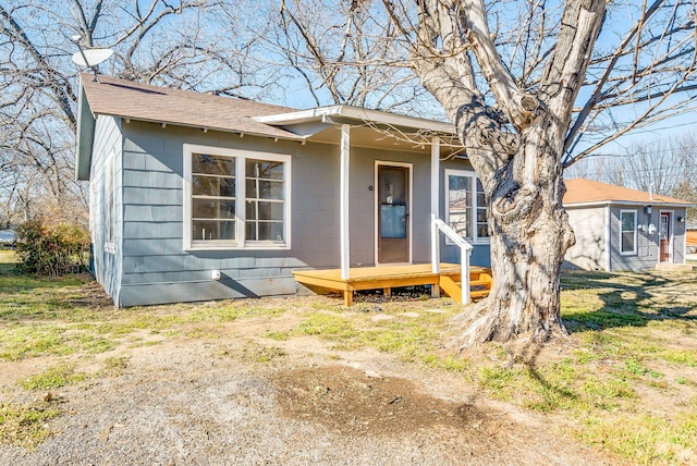 bungalow-style house with roof with shingles