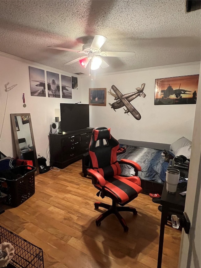 interior space with light wood-style floors, ceiling fan, and a textured ceiling