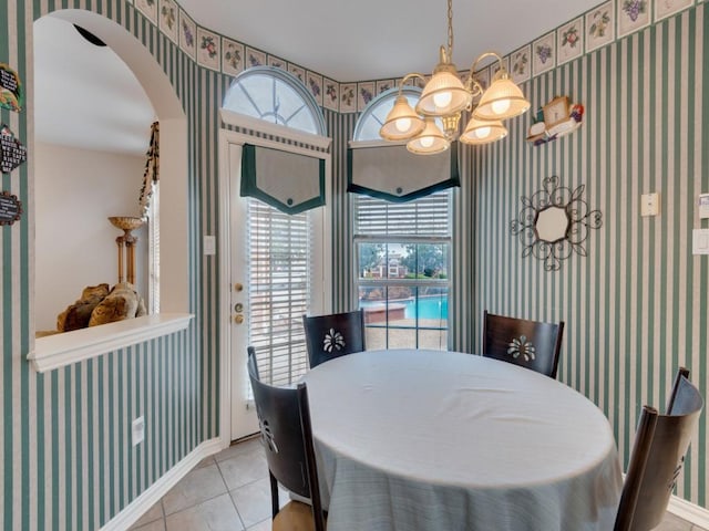 tiled dining room featuring a wealth of natural light, baseboards, and wallpapered walls