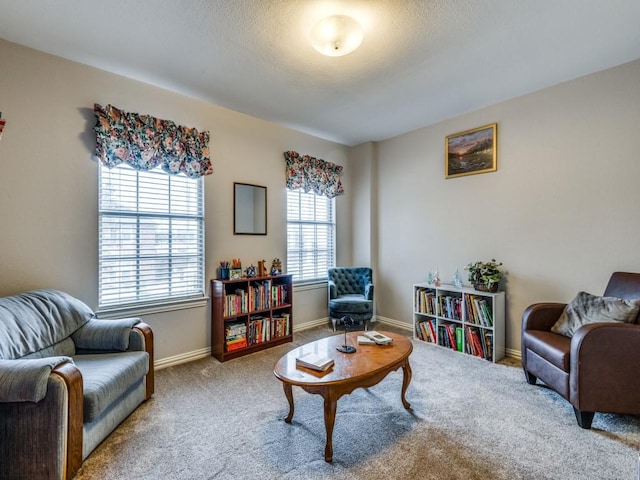 sitting room with a healthy amount of sunlight, baseboards, and carpet