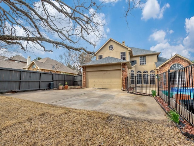 rear view of property featuring fence, an attached garage, a shingled roof, concrete driveway, and brick siding