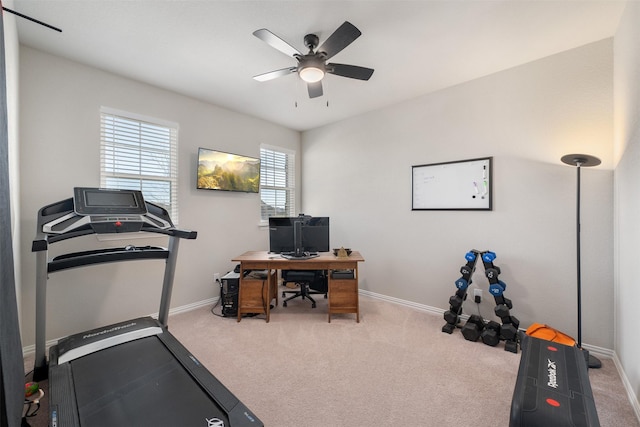 exercise room with carpet flooring, baseboards, and a ceiling fan