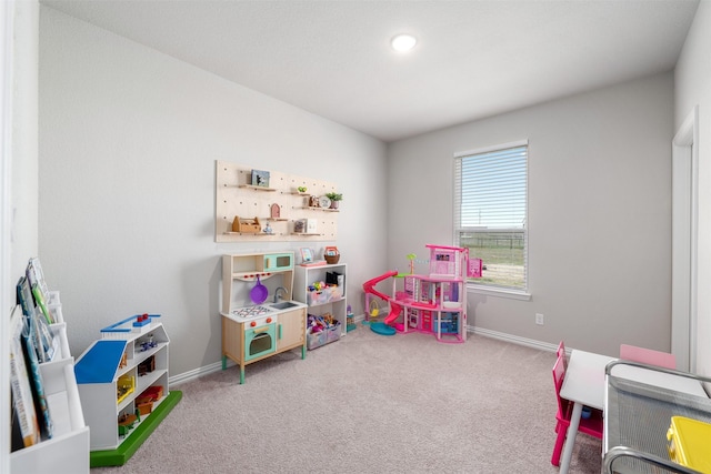 rec room with baseboards and carpet floors