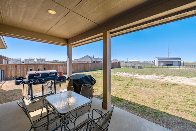 view of patio / terrace featuring a fenced backyard, outdoor dining space, and grilling area