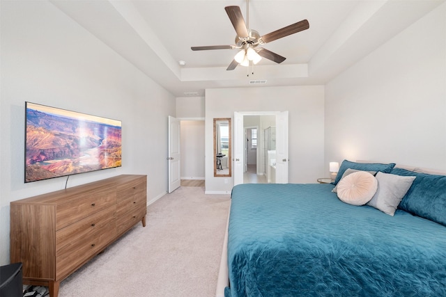 bedroom featuring visible vents, baseboards, ceiling fan, a raised ceiling, and light colored carpet