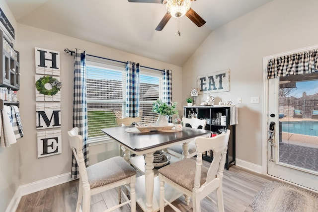 dining space with vaulted ceiling, light wood-type flooring, and plenty of natural light