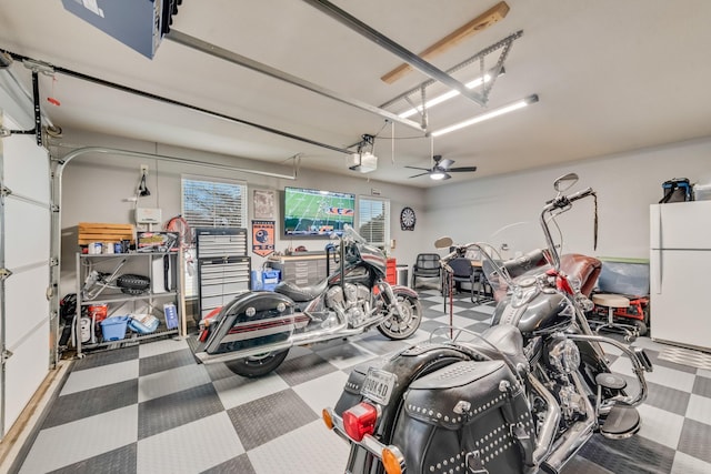 garage featuring a garage door opener and freestanding refrigerator