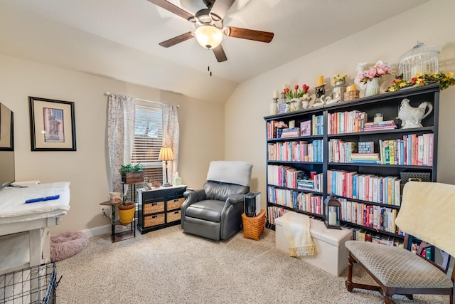 sitting room featuring baseboards, a ceiling fan, vaulted ceiling, and carpet flooring