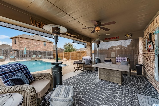 view of patio / terrace featuring an outdoor hangout area, a fenced backyard, a fenced in pool, and a ceiling fan