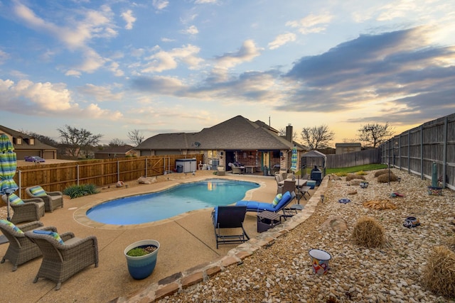 view of swimming pool with a fenced backyard, a fenced in pool, and a patio