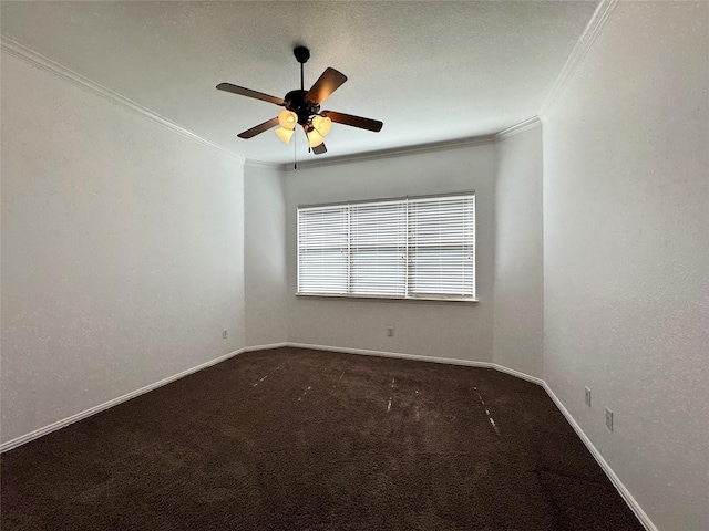 unfurnished room featuring ornamental molding, dark carpet, baseboards, and a ceiling fan