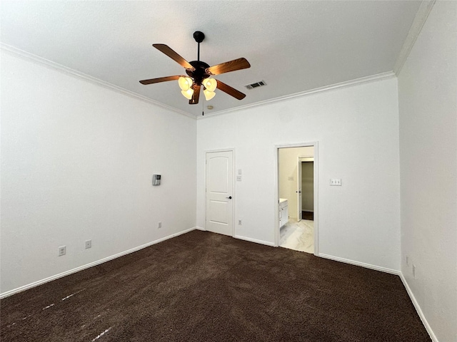 carpeted empty room featuring baseboards, a ceiling fan, visible vents, and crown molding