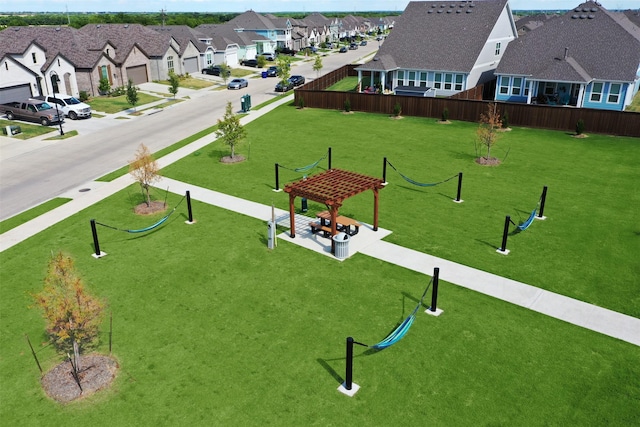 view of community with a residential view, a yard, and a pergola