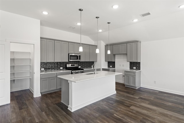 kitchen with appliances with stainless steel finishes, gray cabinets, and a sink